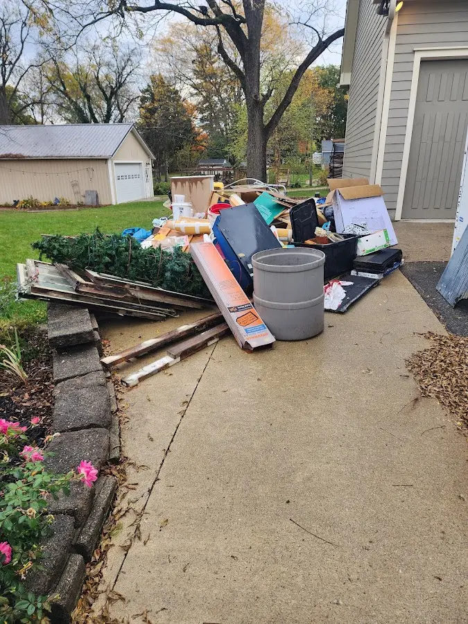 Dumpster being loaded with debris for Commercial Dumpster Rental in Maryland Heights